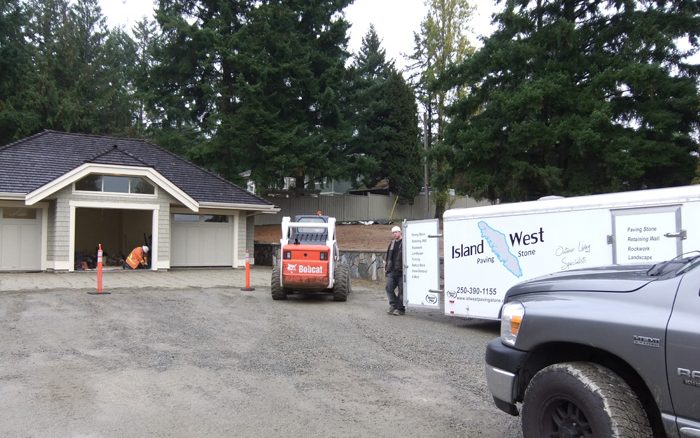 Island West truck, trailer and bobcat on a job site