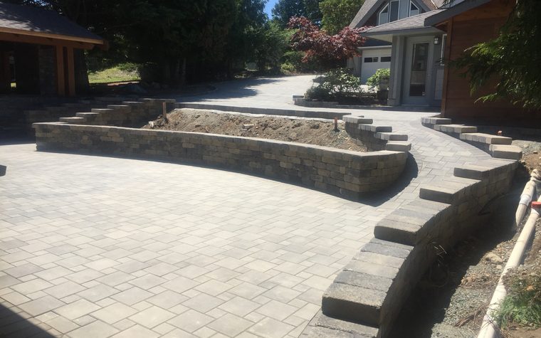 Two-sided block wall around a paving stone patio